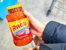 hand holding a jar of ragu pasta sauce