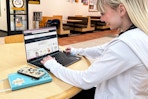 a college student on a laptop in college campus