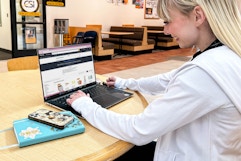 a college student on a laptop in college campus
