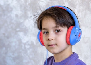 a little kid wearing blue and red