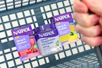 hand holding basket with natrol sleep supplements
