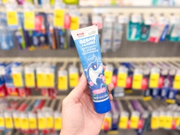 hand holding kids toothpaste in cvs