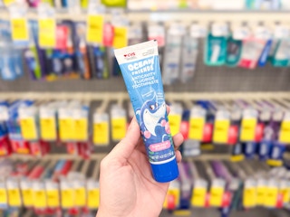 hand holding kids toothpaste in cvs