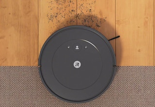 iRobot Roomba vacuuming up dirt on a floor. 