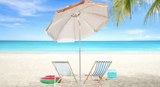 chairs and umbrella laid out at the beach