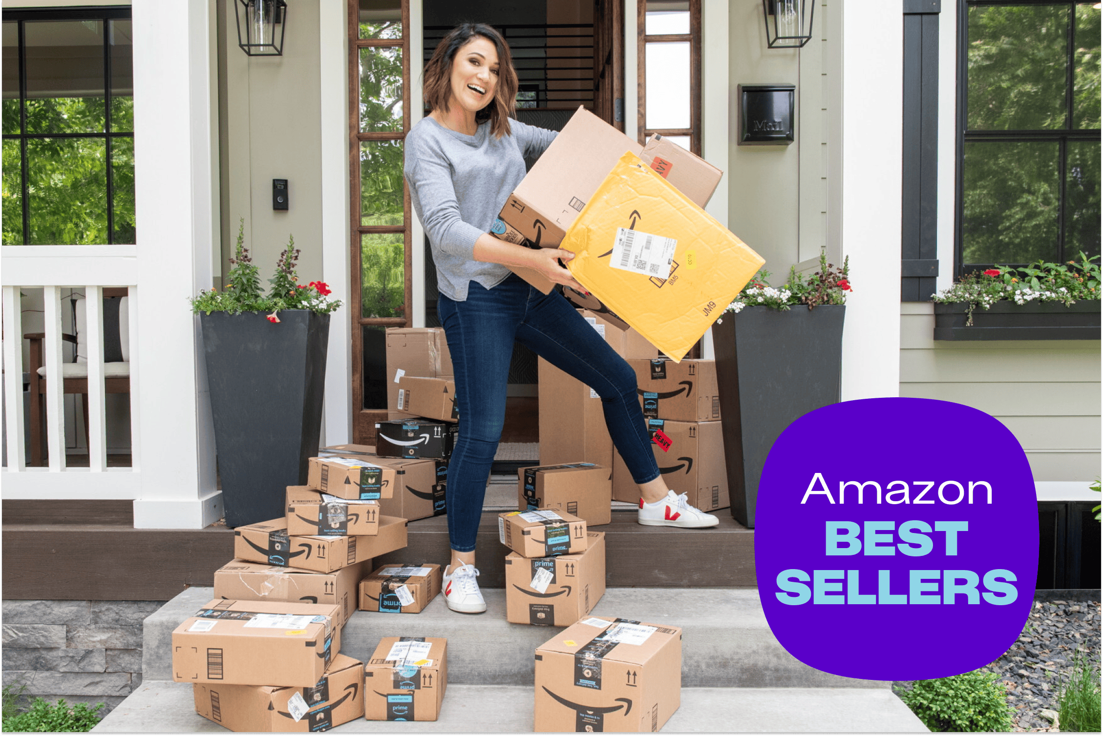 amazon boxes on a porch with joanie holding amazon packages