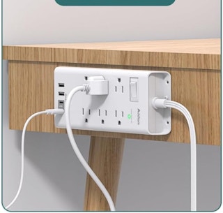 Surge Protector Power Strip on the side of table