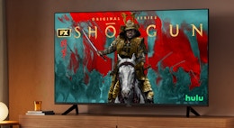 a smart TV on a wooden TV console