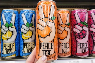hand holding a can of peace tea at kroger