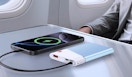 a power bank charging a phone on an airplane