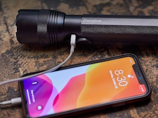 a flashlight charging an iPhone