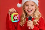 Little girl using the CscyyAmz Mini Karaoke Machine in a Santa hat.