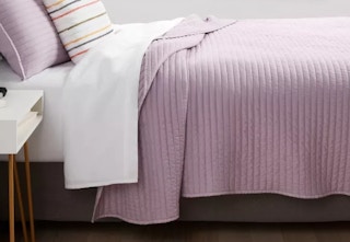 light purple quilt on a bed