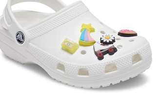White crocs with charms on a white background