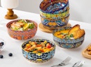 colorful bowls full of food on a table