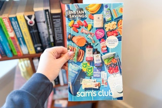 hand holding sams club january instant savings book