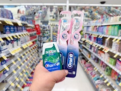 hand holding crest and oral-b products in walgreens