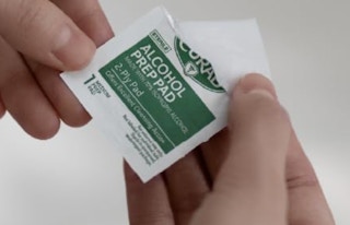 a an alcohol prep pad in two hands