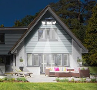 a house with outdoor lights at the top