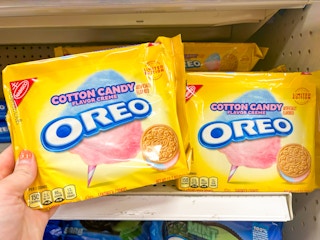 Someone taking some Cotton Candy Oreos from a store shelf