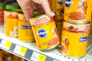 hand grabbing a can of pedigree wet dog food
