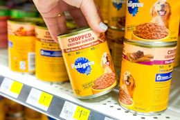 hand grabbing a can of pedigree wet dog food