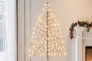 Hairui Lighted Brown Wall Tree 4FT 108 Warm White LED Lights on a wall hanging.