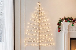 Hairui Lighted Brown Wall Tree 4FT 108 Warm White LED Lights on a wall hanging.