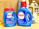 persil detergent on store shelf in front of basket and towel
