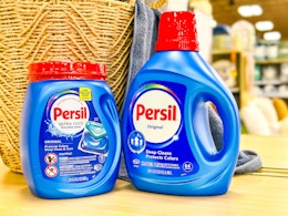 persil detergent on store shelf in front of basket and towel