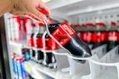hand pickup up a bottle of coca-cola
