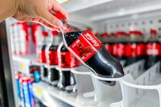 hand pickup up a bottle of coca-cola