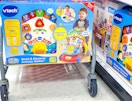 vtech activity walker sitting on the bottom of a target cart
