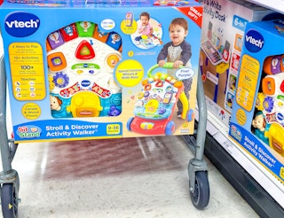 vtech activity walker sitting on the bottom of a target cart