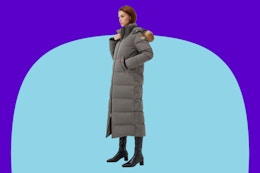 Woman wearing the Fitouch Women's Waukee Long Down Coat Parka on a blue background.