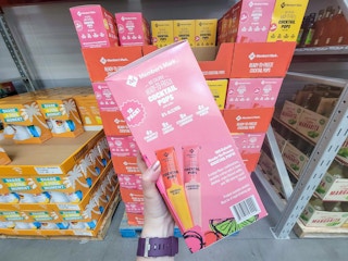 hand holding a box of ready to freeze cocktail popsicles