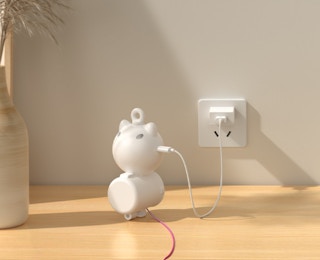 a cat playing with a laser toy behind someone sitting at a table