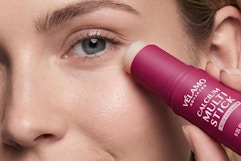 a woman using a calcium multi-stick