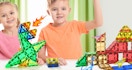 kids playing with dinosaur-themed magnetic tiles
