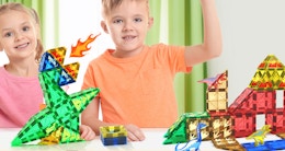 kids playing with dinosaur-themed magnetic tiles