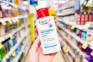 hand holding eucerin body lotion at dollar general