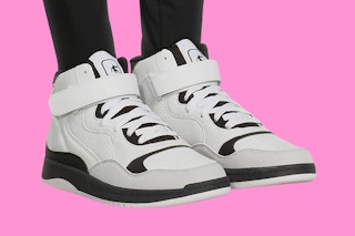 Stock image of AND1 Basketball Women's Sneakers over pink background