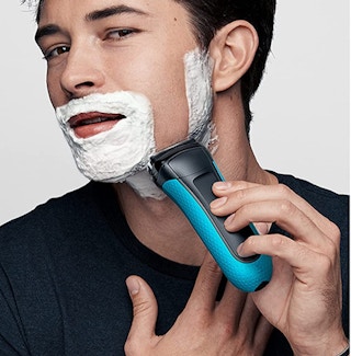 man using an electric razor