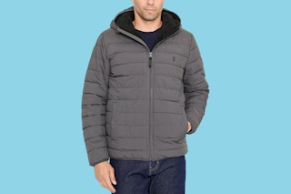 Close up shot of a male model wearing an Izod puffer jacket in the color grey