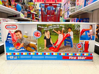 little tikes slide sitting in front of a target cart