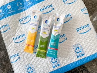 Three Liquid IV packets with an Amazon package