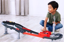 Lifestyle image of the Hot Wheels Sprint Race Circuit Track Set being played with by a small child