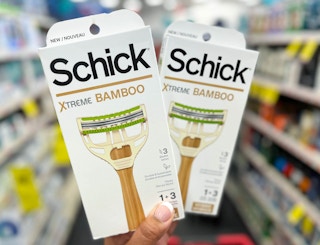 hand holding two boxes of Schick Xtreme Bamboo Razors in aisle