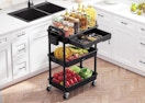 a rolling cart with food and seasoning in a kitchen