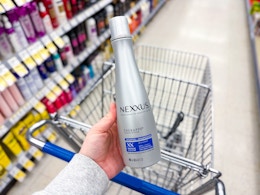 hand holding nexxus shampoo in walgreens